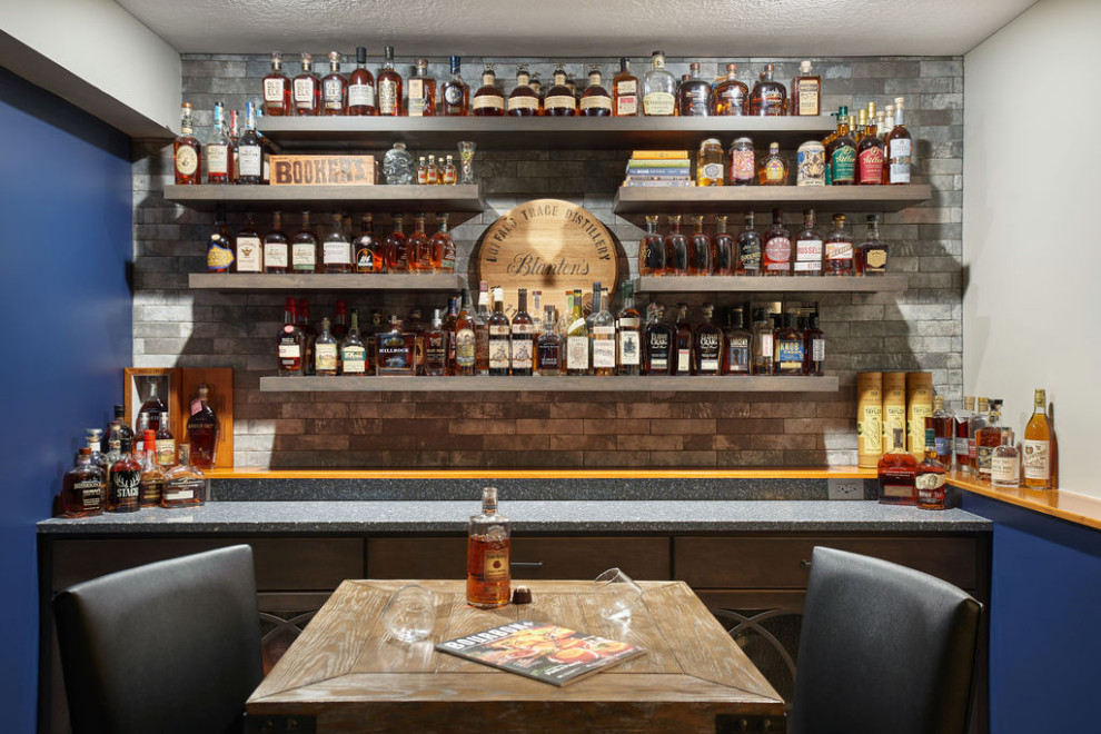 Small transitional single-wall home bar in Columbus with no sink, glass-front cabinets, medium wood cabinets, quartz benchtops, multi-coloured splashback, brick splashback and blue benchtop.