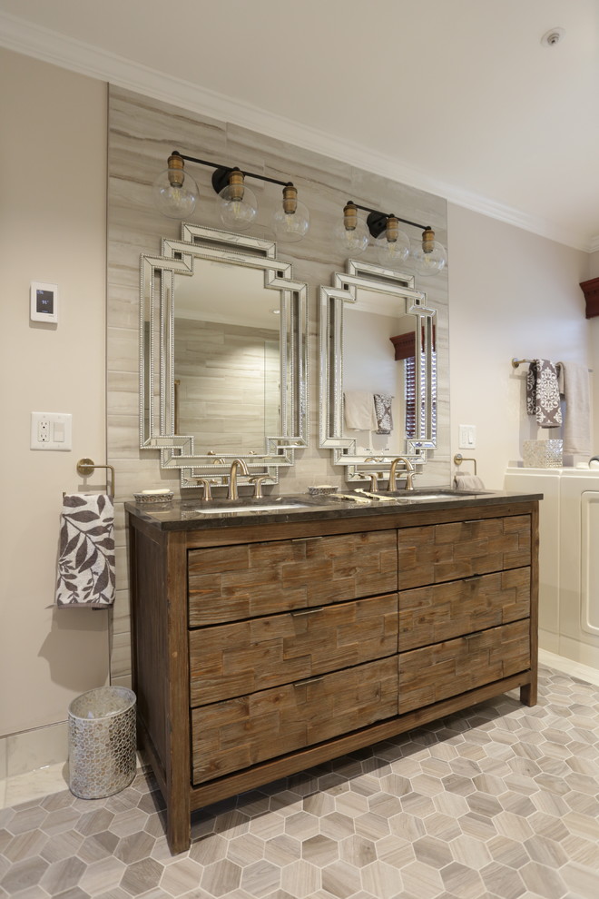 This is an example of a large transitional master bathroom in DC Metro with flat-panel cabinets, medium wood cabinets, a freestanding tub, a double shower, a bidet, white tile, porcelain tile, white walls, porcelain floors, an undermount sink, soapstone benchtops, white floor, an open shower and black benchtops.