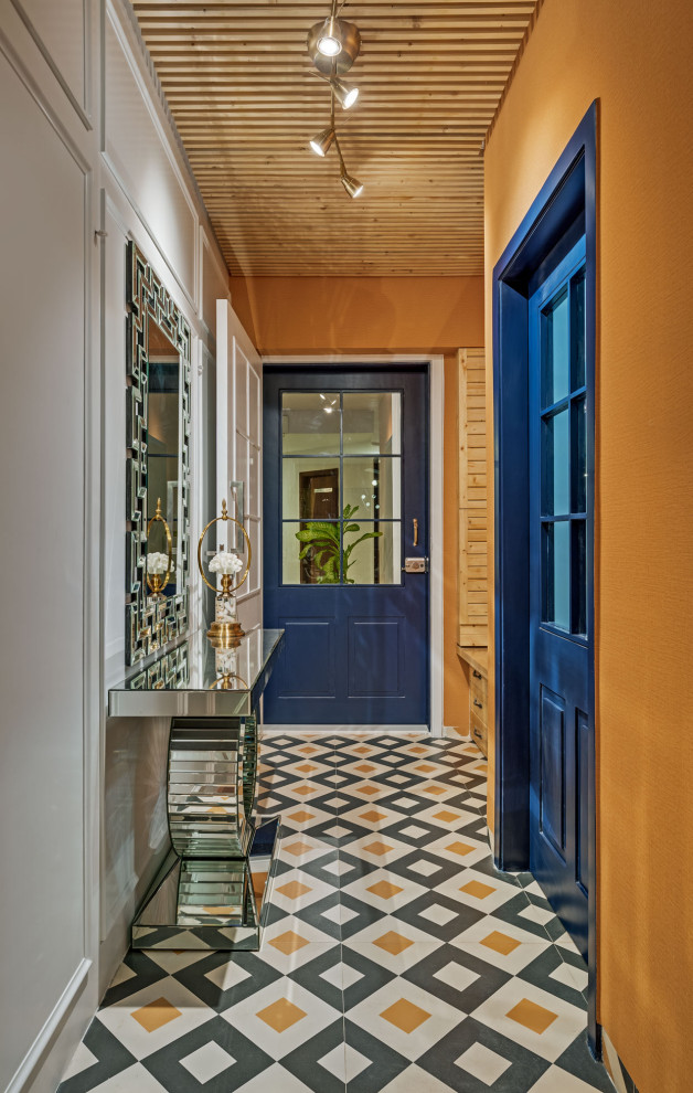 Large contemporary hallway in Bengaluru with orange walls, porcelain floors, multi-coloured floor, wood and decorative wall panelling.