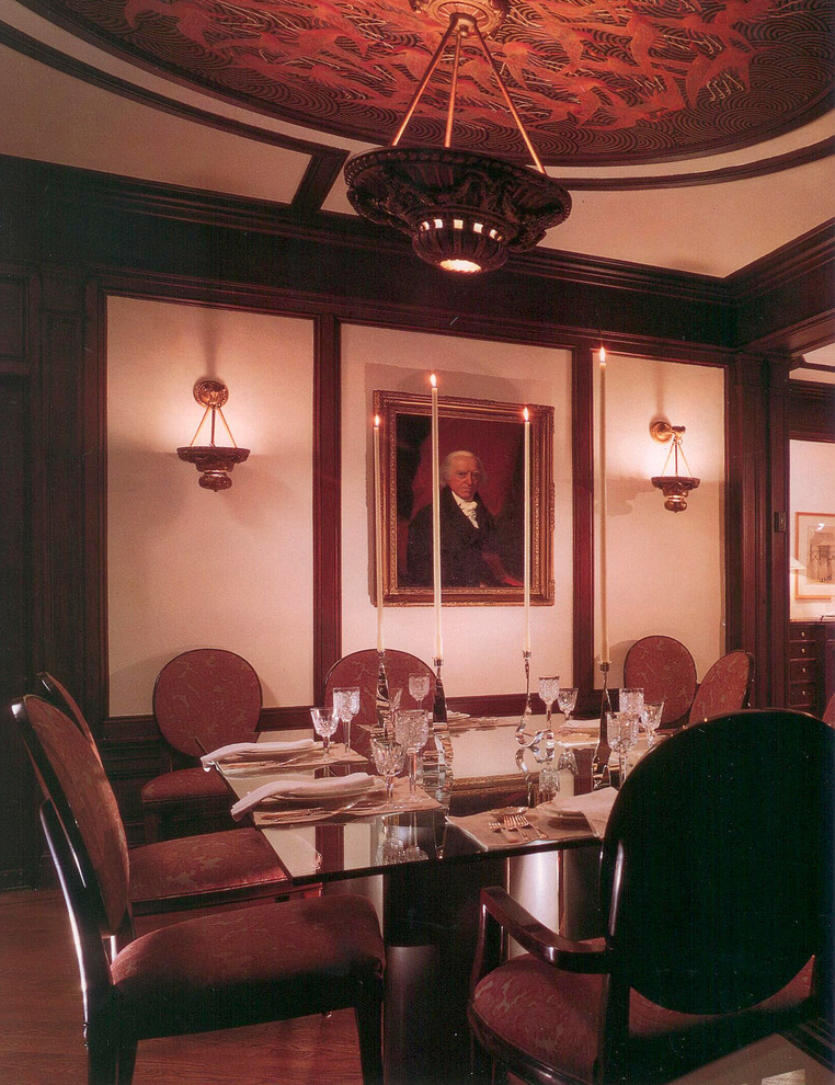 This is an example of a large modern separate dining room in New York with beige walls and medium hardwood floors.