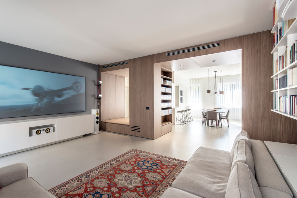 Large contemporary open concept home theatre in Milan with grey walls, concrete floors, grey floor and a wall-mounted tv.