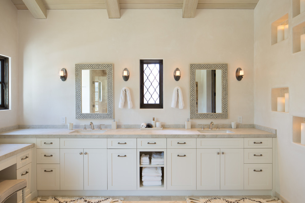 Inspiration for a mediterranean master bathroom in Los Angeles with quartzite benchtops, shaker cabinets, beige cabinets, beige walls, an undermount sink, beige benchtops, limestone floors and beige floor.