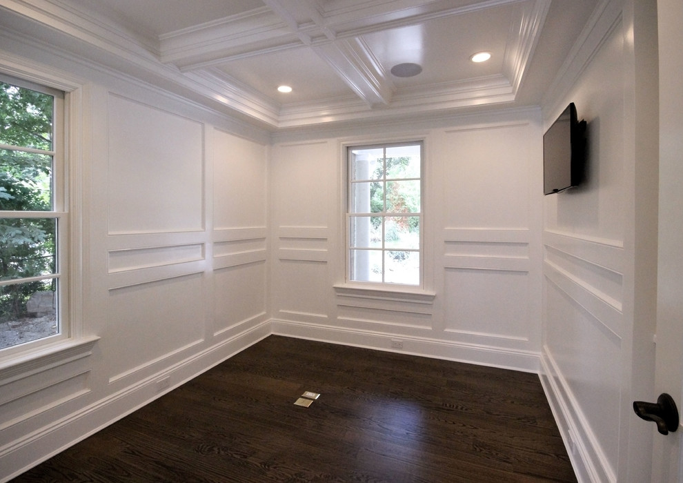 This is an example of a mid-sized transitional home office in New York with white walls and dark hardwood floors.