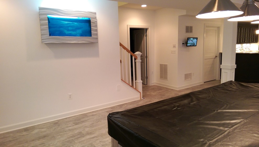 Photo of an expansive transitional fully buried basement in DC Metro with beige walls, porcelain floors and beige floor.