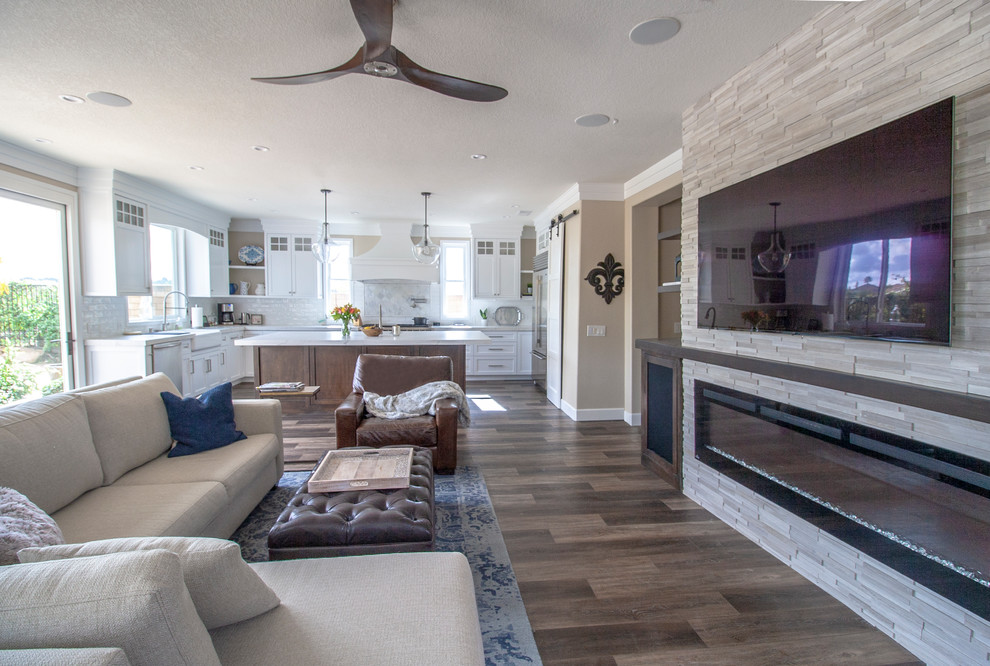 Inspiration for a mid-sized modern open concept family room in Orange County with beige walls, dark hardwood floors, a ribbon fireplace, a tile fireplace surround, a wall-mounted tv and brown floor.