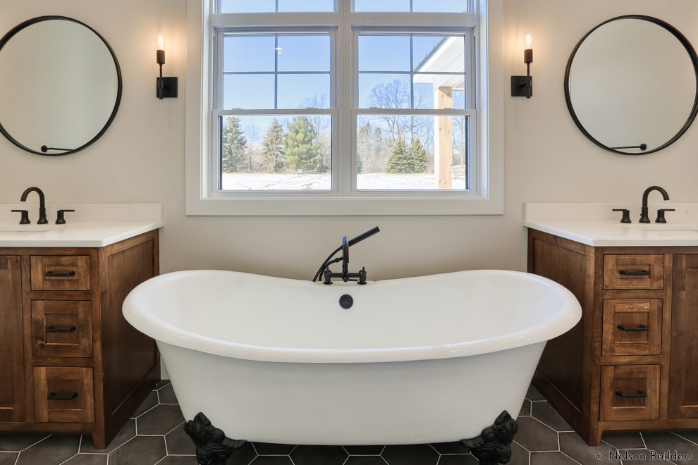 Inspiration for a mid-sized country master bathroom in Chicago with shaker cabinets, medium wood cabinets, a claw-foot tub, a curbless shower, beige walls, cement tiles, an undermount sink, engineered quartz benchtops, grey floor, an open shower, white benchtops, an enclosed toilet, a double vanity and a freestanding vanity.