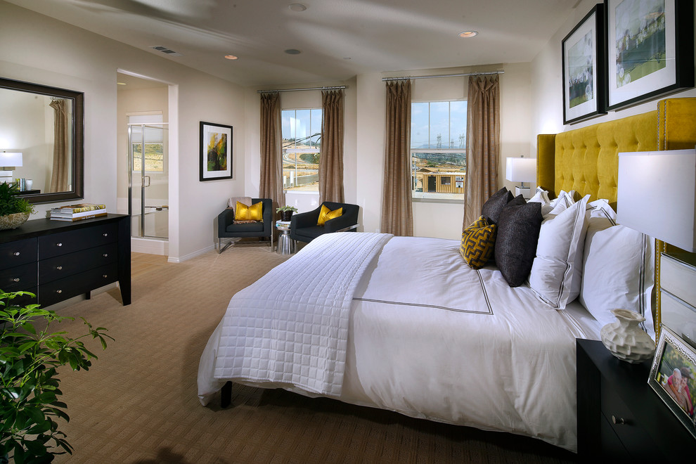 This is an example of a contemporary master bedroom in Los Angeles with beige walls, carpet and no fireplace.