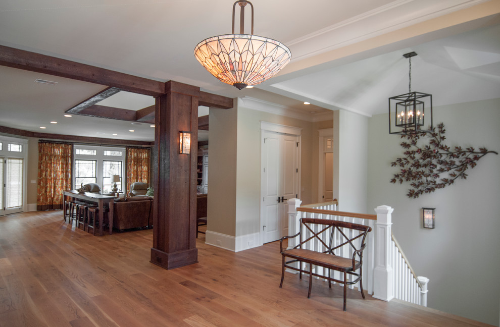 This is an example of a large arts and crafts hallway in Charlotte with medium hardwood floors and beige walls.