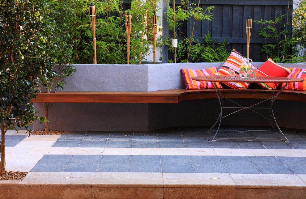 This is an example of a mid-sized contemporary courtyard shaded garden for spring in Sydney with natural stone pavers.