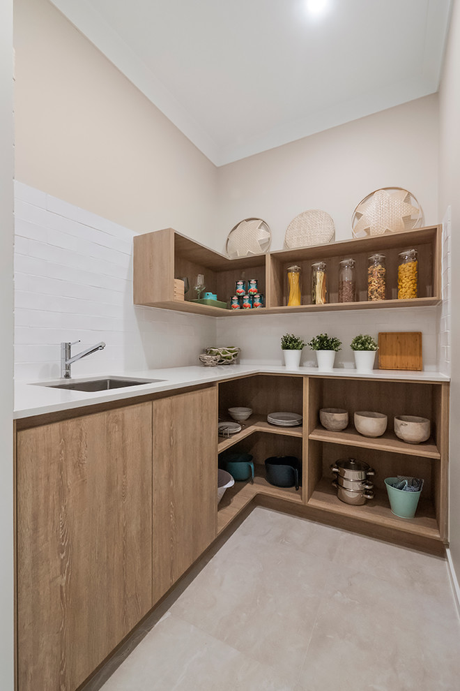 Inspiration for a contemporary kitchen pantry in Brisbane with ceramic splashback, ceramic floors, beige floor, an undermount sink, open cabinets, medium wood cabinets and white splashback.
