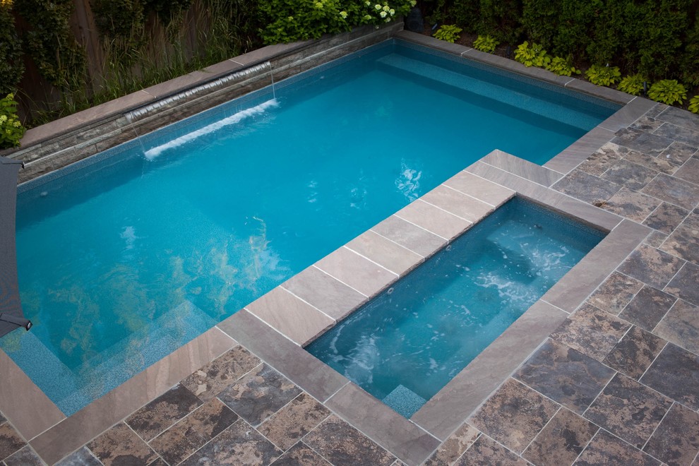 Small transitional backyard stone and rectangular hot tub photo in Toronto