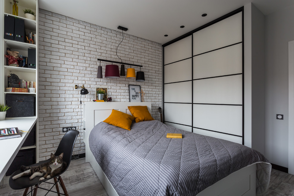 Photo of a mid-sized contemporary bedroom in Saint Petersburg with white walls, medium hardwood floors and grey floor.