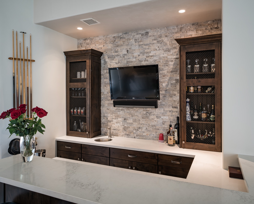 Inspiration for a small modern u-shaped wet bar in Minneapolis with dark wood cabinets, laminate benchtops, beige splashback, stone tile splashback and recessed-panel cabinets.