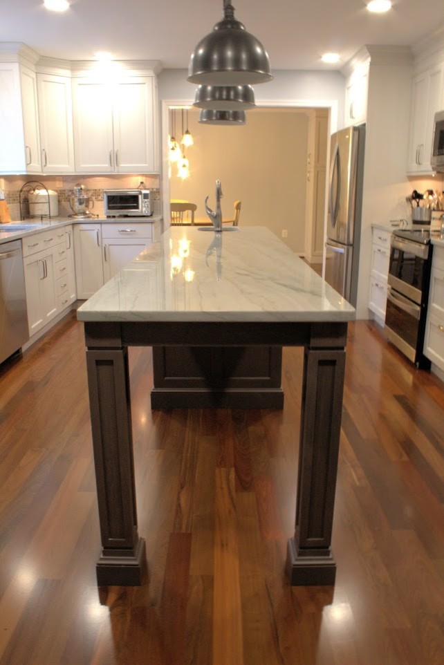Inspiration for a large transitional galley medium tone wood floor and brown floor eat-in kitchen remodel in Baltimore with a single-bowl sink, recessed-panel cabinets, white cabinets, quartzite countertops, gray backsplash, glass tile backsplash, stainless steel appliances, an island and multicolored countertops