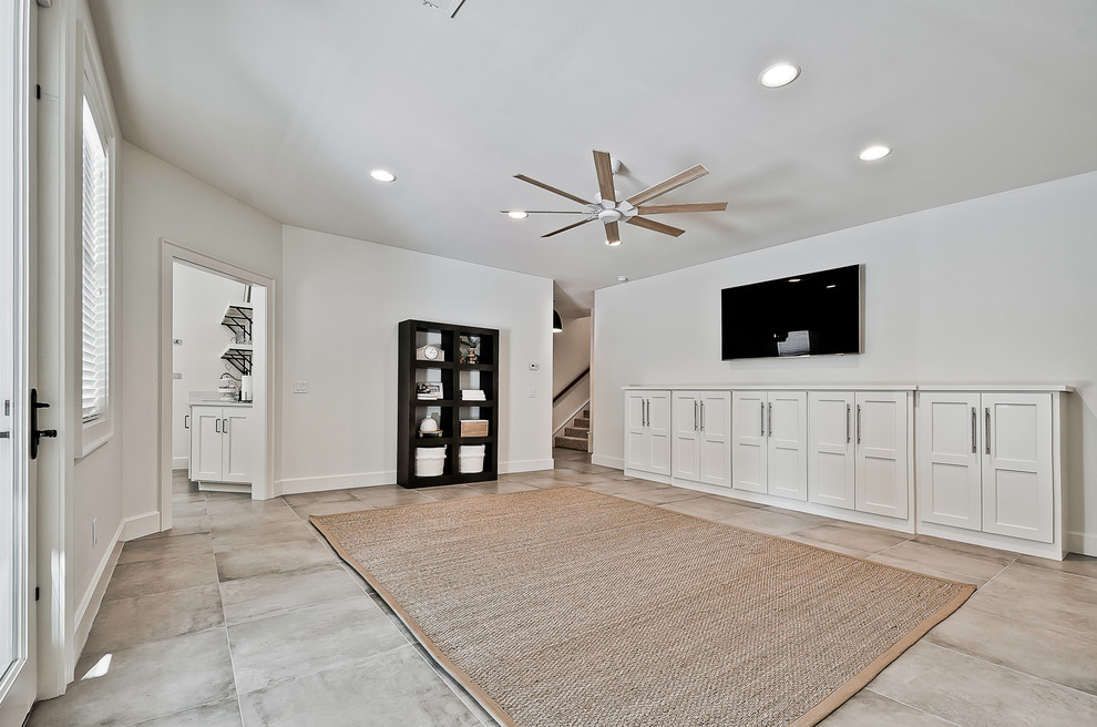 This is an example of a large arts and crafts walk-out basement in Other with white walls, porcelain floors and blue floor.