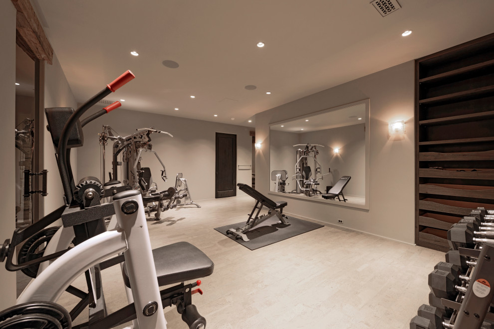 This is an example of a large traditional home weight room in DC Metro with grey walls, ceramic flooring and beige floors.