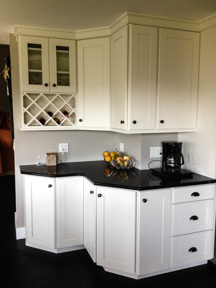 Inspiration for a large transitional l-shaped open concept kitchen remodel with a farmhouse sink, shaker cabinets, white cabinets, quartz countertops, stainless steel appliances and an island