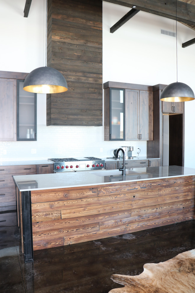 Inspiration for a large rustic galley brown floor and vaulted ceiling open concept kitchen remodel with an undermount sink, shaker cabinets, dark wood cabinets, quartz countertops, white backsplash, ceramic backsplash, stainless steel appliances, an island and white countertops