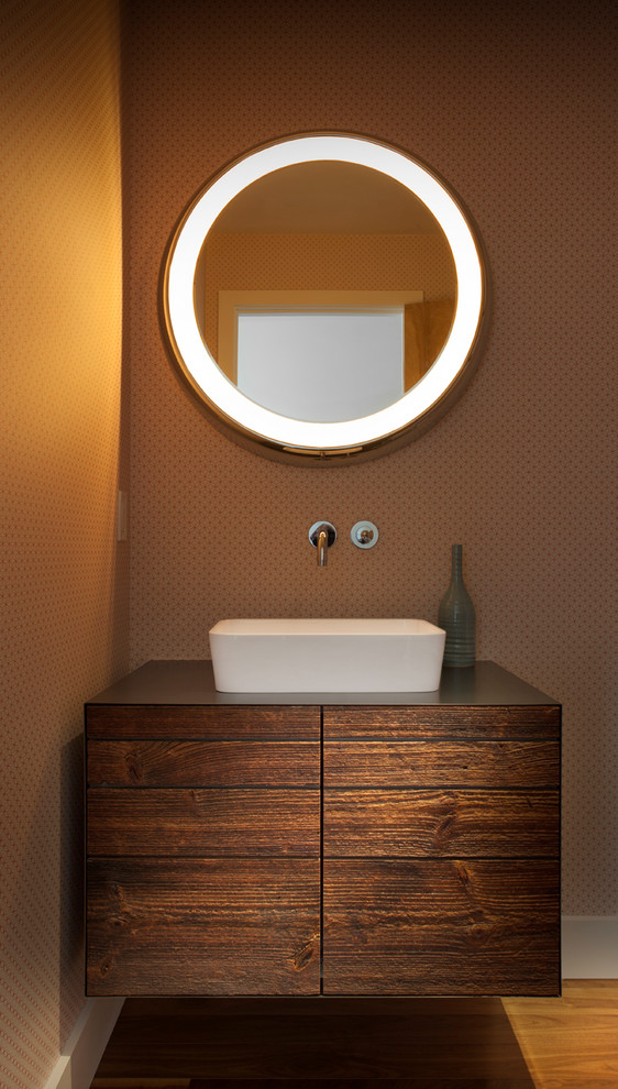 Design ideas for a mid-sized contemporary powder room in Denver with a vessel sink, brown walls, flat-panel cabinets, dark wood cabinets, medium hardwood floors, wood benchtops and brown benchtops.