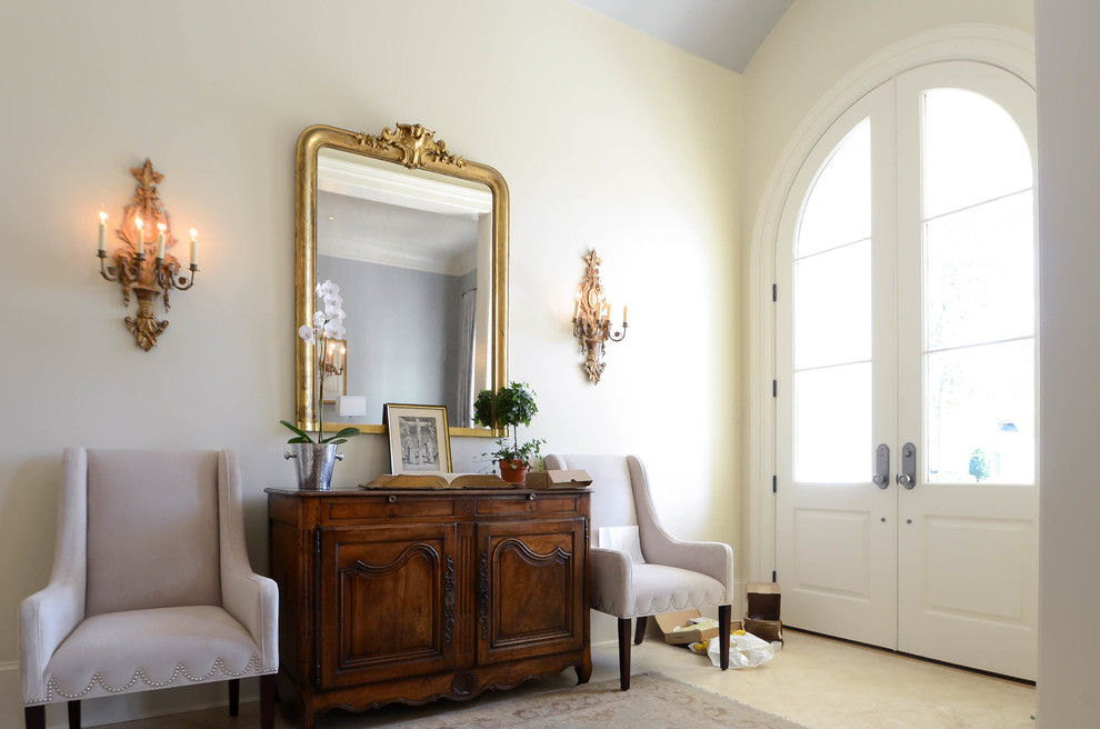 Mid-sized traditional foyer in New Orleans with beige walls, a double front door, a white front door and travertine floors.