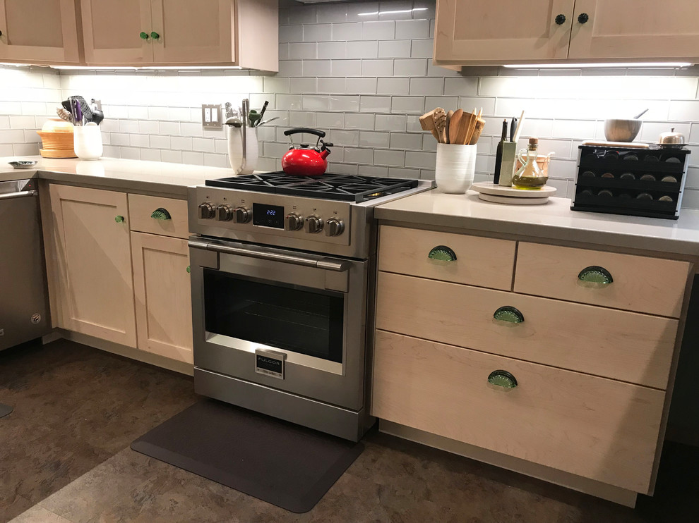 Eat-in kitchen - small modern eat-in kitchen idea in Other with an undermount sink, light wood cabinets, gray backsplash, glass tile backsplash, stainless steel appliances and beige countertops
