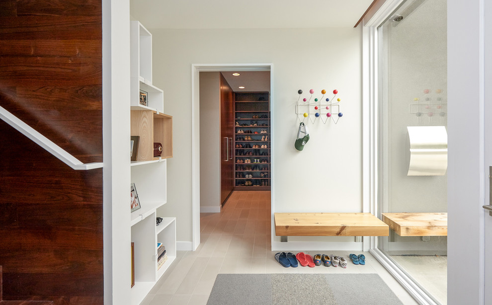 Design ideas for a mid-sized midcentury mudroom in Minneapolis with white walls and porcelain floors.