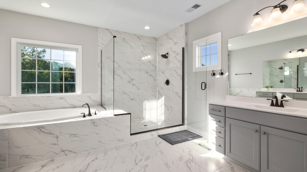 A spacious bathroom with marble flooring and white walls, featuring a modern spa-like design.