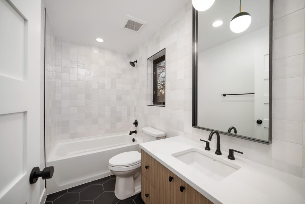 Example of an urban kids' white tile and ceramic tile ceramic tile, black floor and single-sink bathroom design in Denver with flat-panel cabinets, brown cabinets, a two-piece toilet, white walls, an undermount sink, quartzite countertops, white countertops and a floating vanity