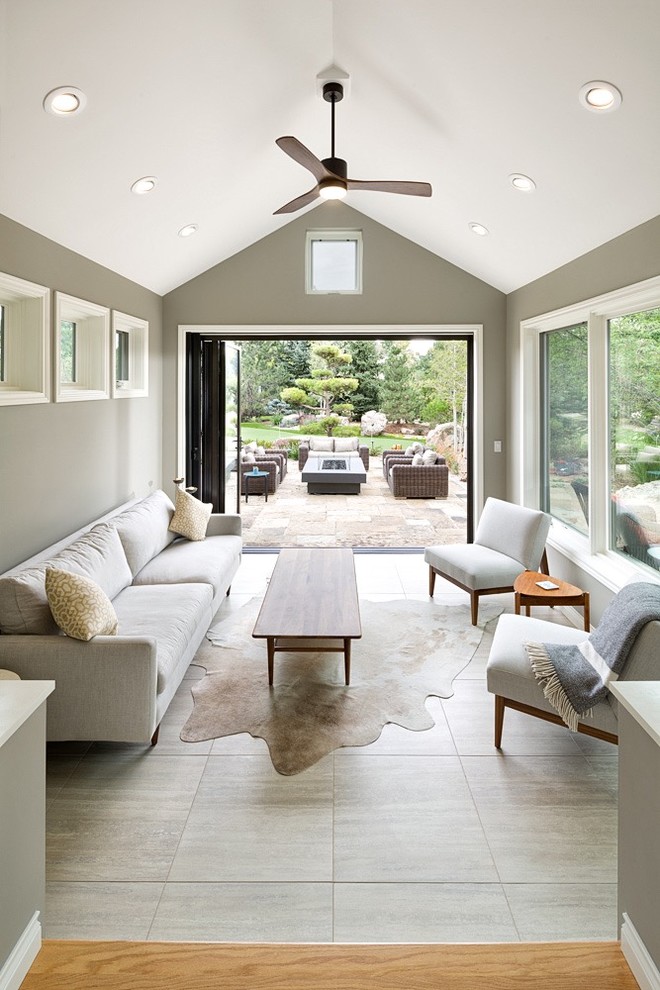 Design ideas for a mid-sized transitional sunroom in Denver with porcelain floors, a standard ceiling and beige floor.
