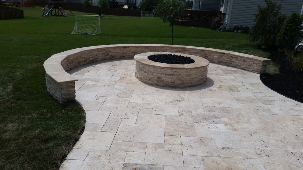 This is an example of a mid-sized mediterranean backyard patio in Indianapolis with natural stone pavers.