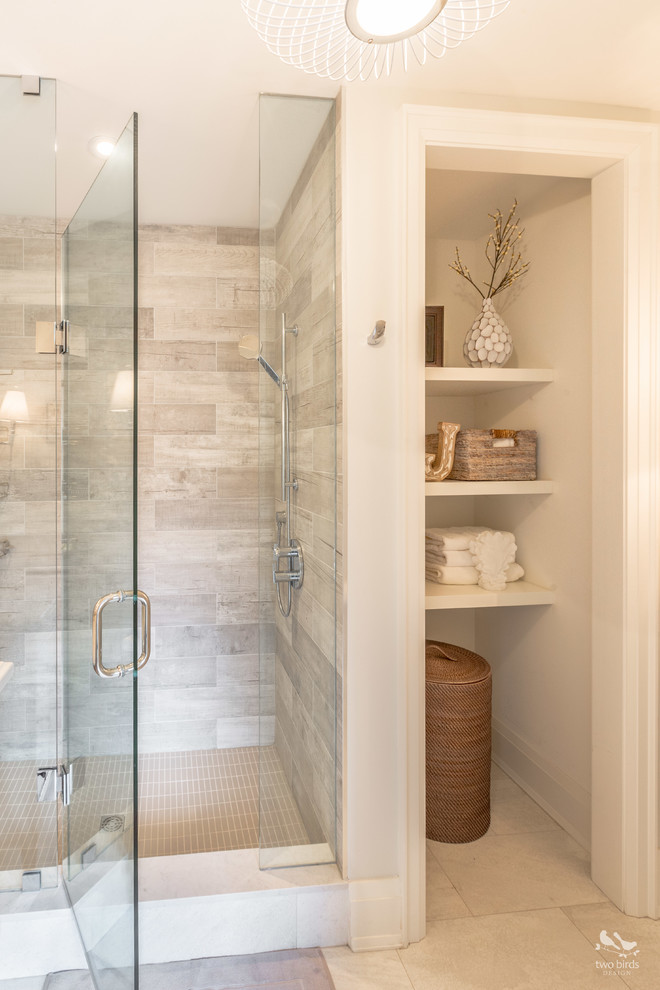 This is an example of a mid-sized transitional 3/4 bathroom in Toronto with shaker cabinets, distressed cabinets, a corner shower, a two-piece toilet, gray tile, porcelain tile, grey walls, porcelain floors, an undermount sink, engineered quartz benchtops, beige floor and a hinged shower door.
