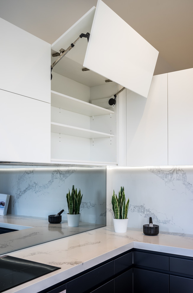 Design ideas for a mid-sized contemporary separate kitchen in Sydney with white cabinets, white splashback, no island, flat-panel cabinets, marble benchtops, marble splashback and black appliances.