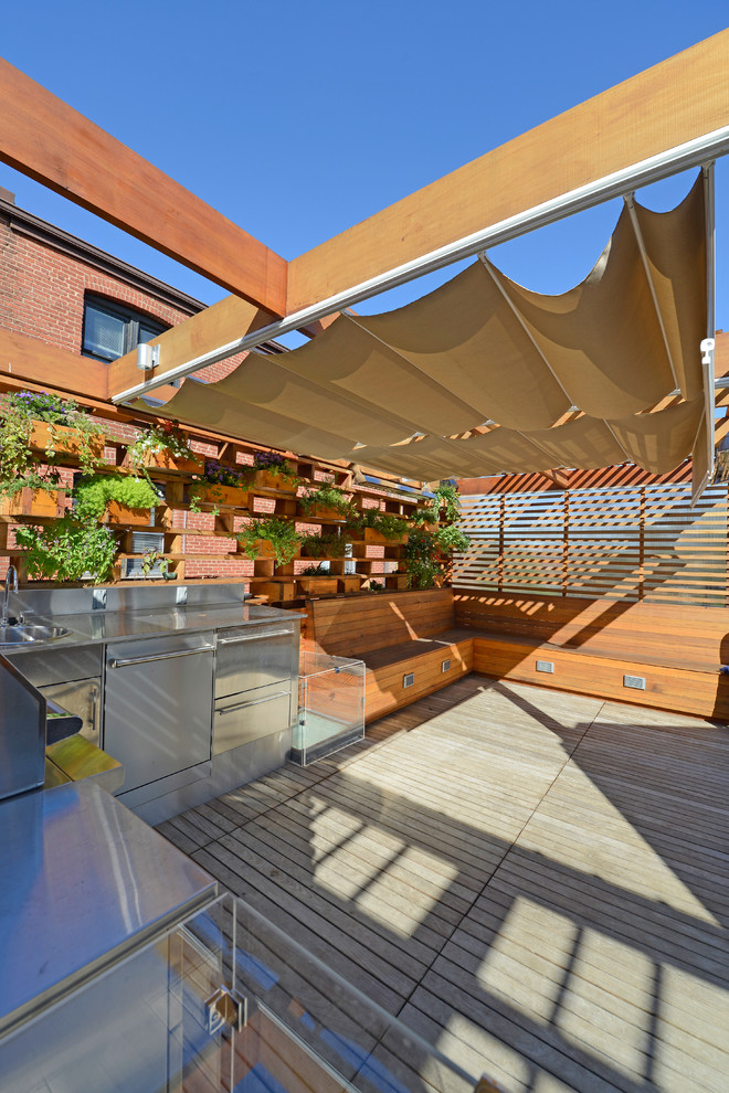 This is an example of a small modern rooftop deck in DC Metro with an outdoor kitchen and a pergola.