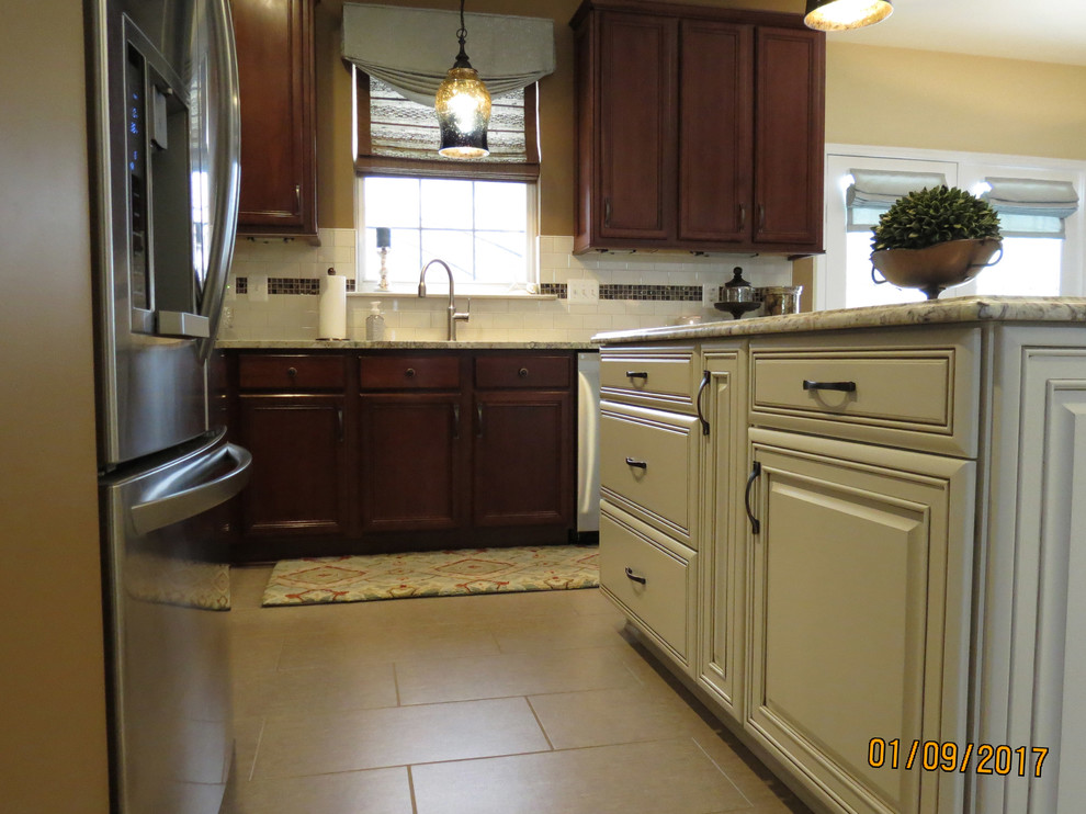 Eat-in kitchen - mid-sized transitional l-shaped ceramic tile eat-in kitchen idea with an undermount sink, raised-panel cabinets, distressed cabinets, granite countertops, white backsplash, porcelain backsplash, stainless steel appliances and an island