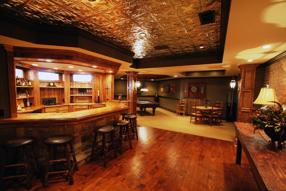 This is an example of a large country look-out basement in Atlanta with medium hardwood floors and brown floor.
