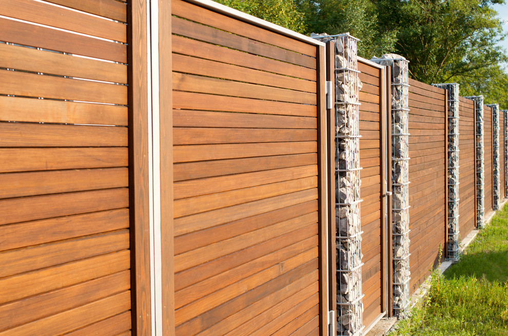 Современный забор из ромбуса лиственницы с габионами