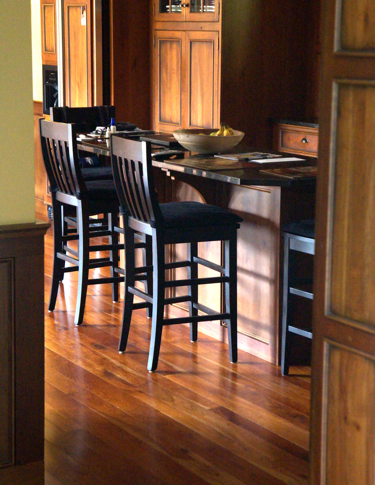 Eat-in kitchen - mid-sized rustic l-shaped medium tone wood floor eat-in kitchen idea in New York with an undermount sink, shaker cabinets, distressed cabinets, granite countertops, multicolored backsplash, stone slab backsplash, stainless steel appliances, yellow walls and an island