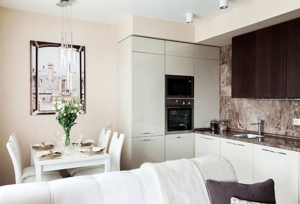 Inspiration for a small contemporary open plan kitchen in Moscow with a drop-in sink, flat-panel cabinets, brown splashback, stone tile splashback, stainless steel appliances, no island and white cabinets.