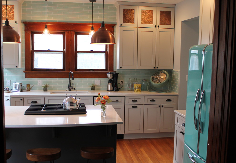 Mid-sized transitional medium tone wood floor kitchen photo with an undermount sink, shaker cabinets, white cabinets, quartz countertops, blue backsplash, subway tile backsplash and an island