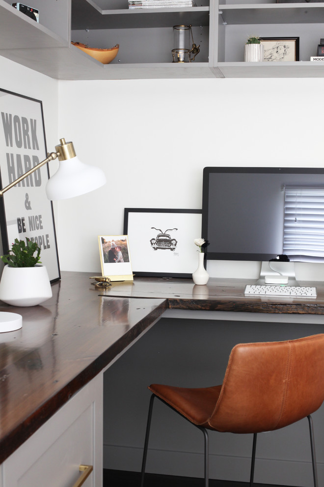 Example of a small transitional built-in desk dark wood floor and brown floor home office design in Chicago