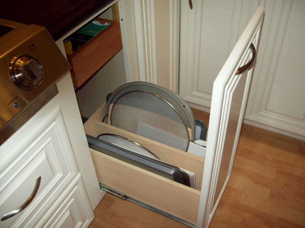Eat-in kitchen - transitional eat-in kitchen idea with raised-panel cabinets, white cabinets, wood countertops and an island