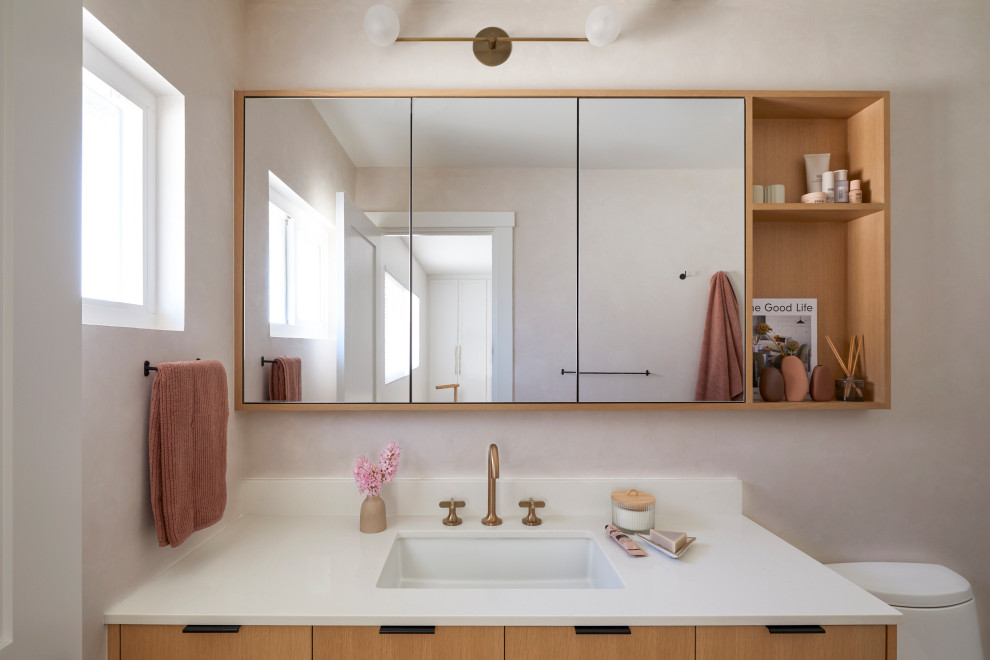 Inspiration for a small scandinavian master bathroom in San Francisco with flat-panel cabinets, brown cabinets, a curbless shower, white tile, ceramic tile, pink walls, terrazzo floors, an undermount sink, engineered quartz benchtops, pink floor, an open shower, white benchtops, a niche, a single vanity and a floating vanity.