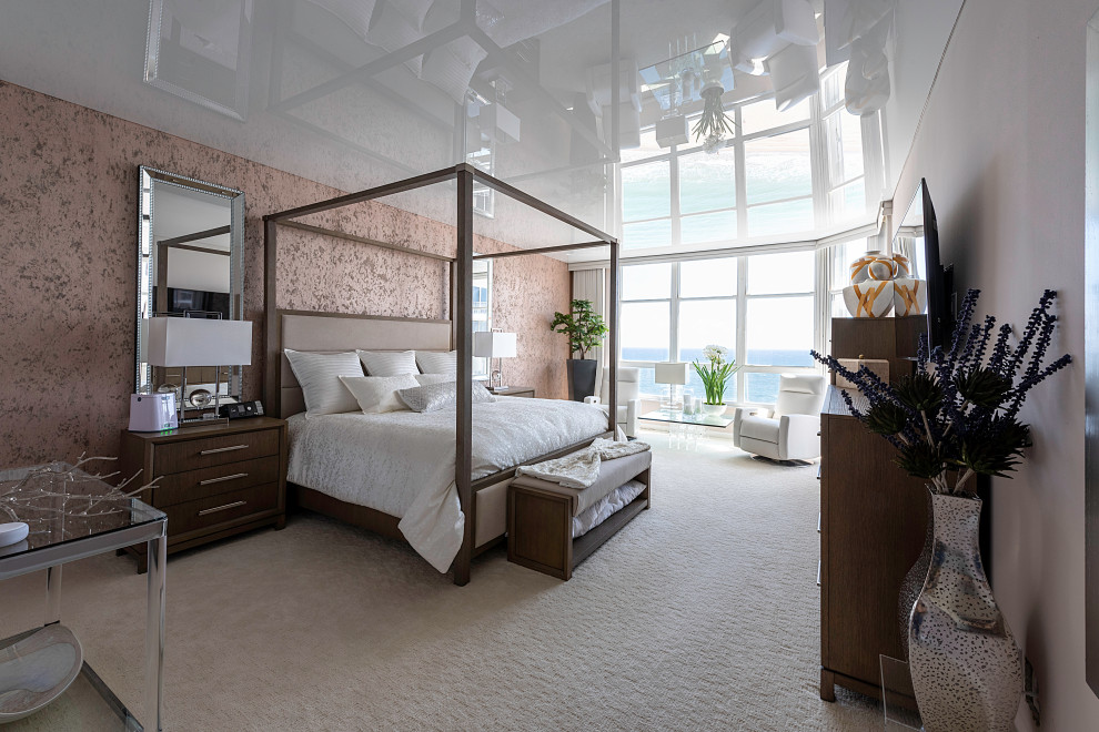 Modern master bedroom in Miami with pink walls, carpet, beige floor, wallpaper and wallpaper.