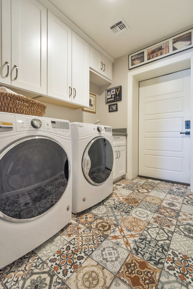 This is an example of a small transitional single-wall dedicated laundry room in Phoenix with a drop-in sink, shaker cabinets, white cabinets, grey walls, porcelain floors, a side-by-side washer and dryer and multi-coloured floor.