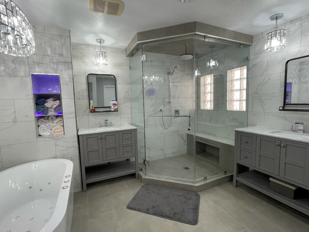 Design ideas for a small contemporary master bathroom in Las Vegas with flat-panel cabinets, grey cabinets, a freestanding tub, a corner shower, a two-piece toilet, gray tile, porcelain tile, grey walls, porcelain floors, an undermount sink, marble benchtops, grey floor, a hinged shower door, white benchtops, a shower seat, a single vanity and a freestanding vanity.