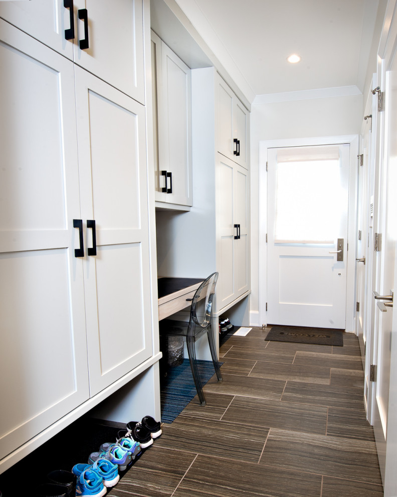 Photo of a contemporary mudroom in Chicago with white walls, painted wood floors, a single front door, a white front door, multi-coloured floor and planked wall panelling.