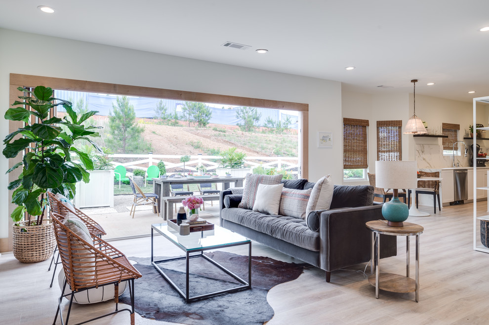 Mid-sized modern open concept living room in Orange County with white walls, light hardwood floors, no fireplace, no tv and beige floor.