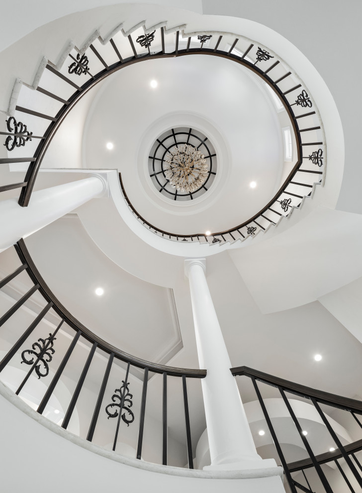 Staircase - huge transitional marble spiral metal railing staircase idea with marble risers