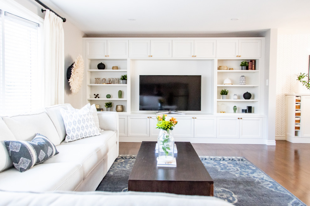 Design ideas for a large transitional open concept living room in Toronto with grey walls and a built-in media wall.