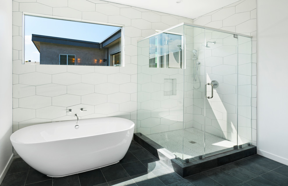 This is an example of a small modern master bathroom in Los Angeles with flat-panel cabinets, white cabinets, a freestanding tub, a corner shower, a one-piece toilet, white tile, cement tile, white walls, ceramic floors, a drop-in sink, engineered quartz benchtops, grey floor, a hinged shower door and white benchtops.